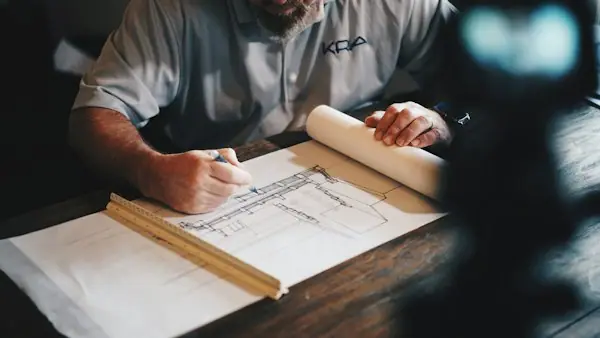 Architects and engineers reviewing blueprints in a conference room